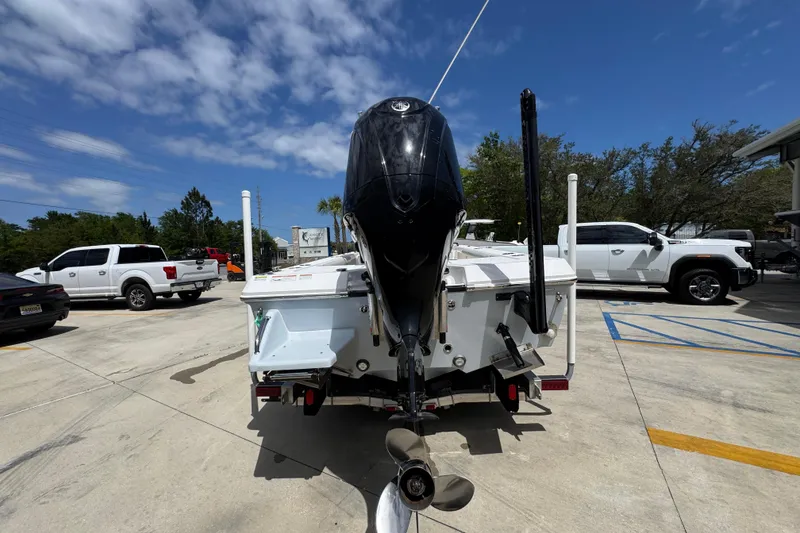 Slide: The Image of 2022 Everglades 243 Center Console boat with outboard motor in a parking lot. - 12