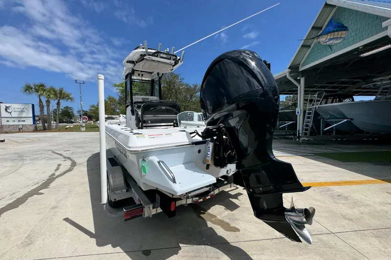 Slide: The Image of 2022 Everglades 243 Center Console boat with powerful outboard motor at marina. - 13
