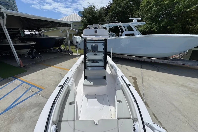 Slide: The Image of 2022 Everglades 243 Center Console boat displayed outdoors on a sunny day. - 19