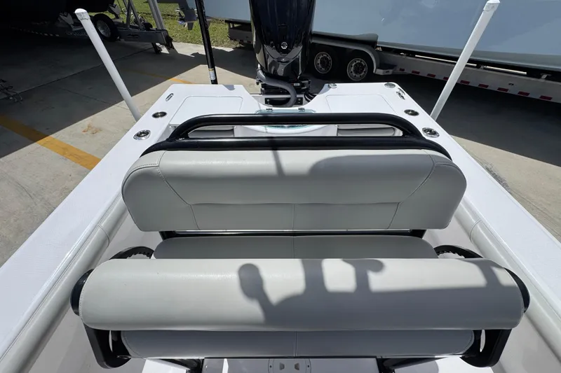 Slide: The Image of 2022 Everglades 243 Center Console boat interior with cushioned seating and console view. - 24