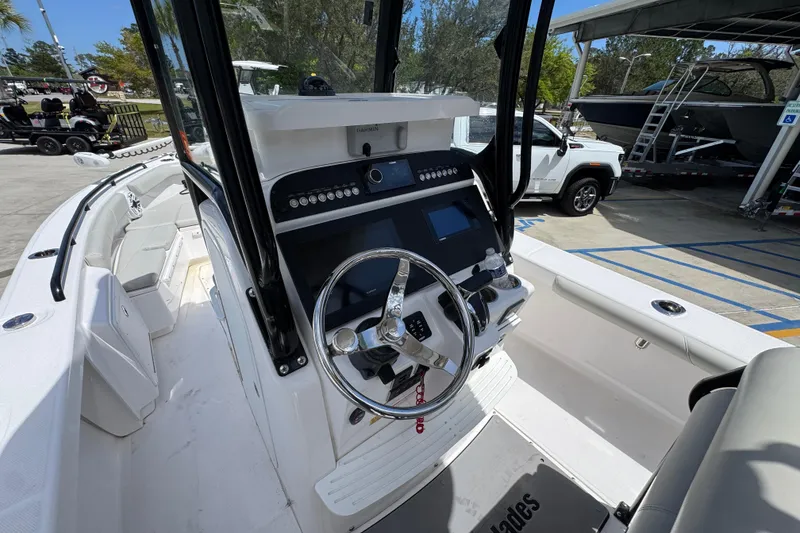 Slide: The Image of 2022 Everglades 243 Center Console boat interior with steering wheel and control panel. - 26