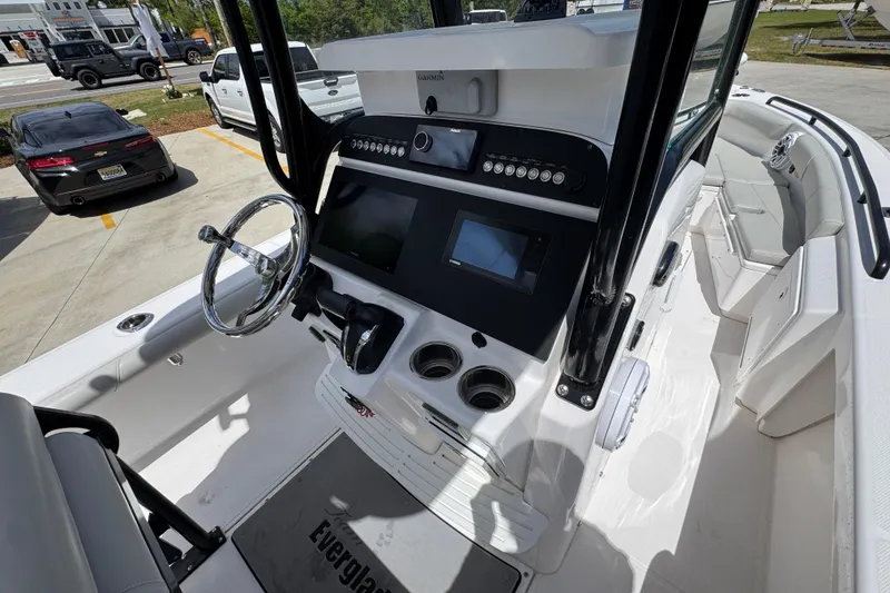 Slide: The Image of 2022 Everglades 243 Center Console boat interior with steering wheel and control panel. - 28