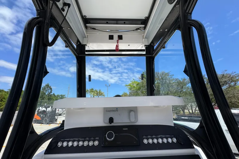 Slide: The Image of Interior view of 2022 Everglades 243 Center Console boat cockpit under clear blue sky. - 29