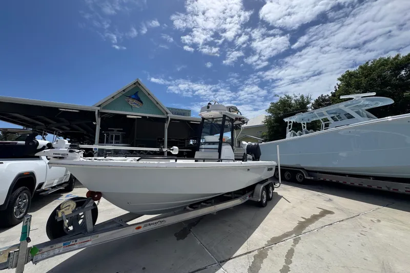 Slide: The Image of 2022 Everglades 243 Center Console boat on trailer under clear blue sky. - 3