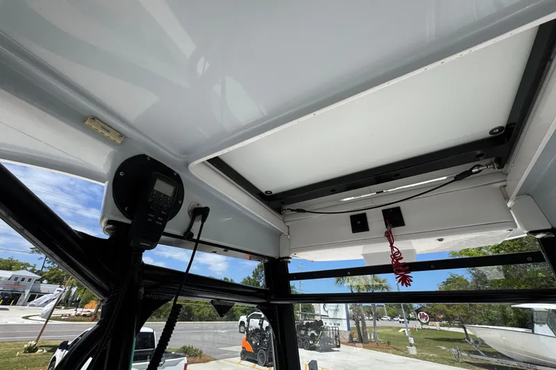 Slide: The Image of Interior view of 2022 Everglades 243 Center Console boat, showcasing electronics and roof details. - 30