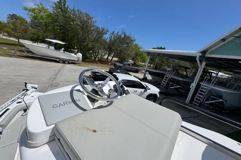 Slide: The Image of 2022 Everglades 243 Center Console boat with Garmin equipment, parked near other boats. - 31