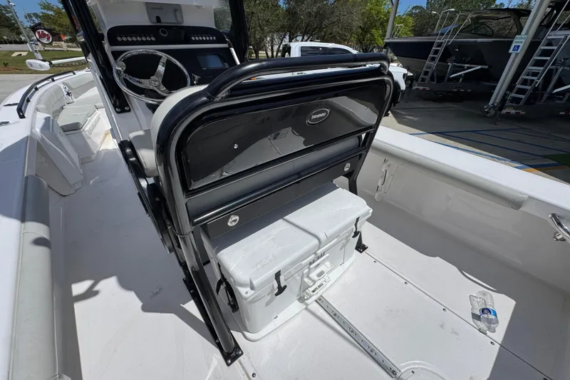 Slide: The Image of 2022 Everglades 243 Center Console boat interior with steering wheel and cooler. - 33