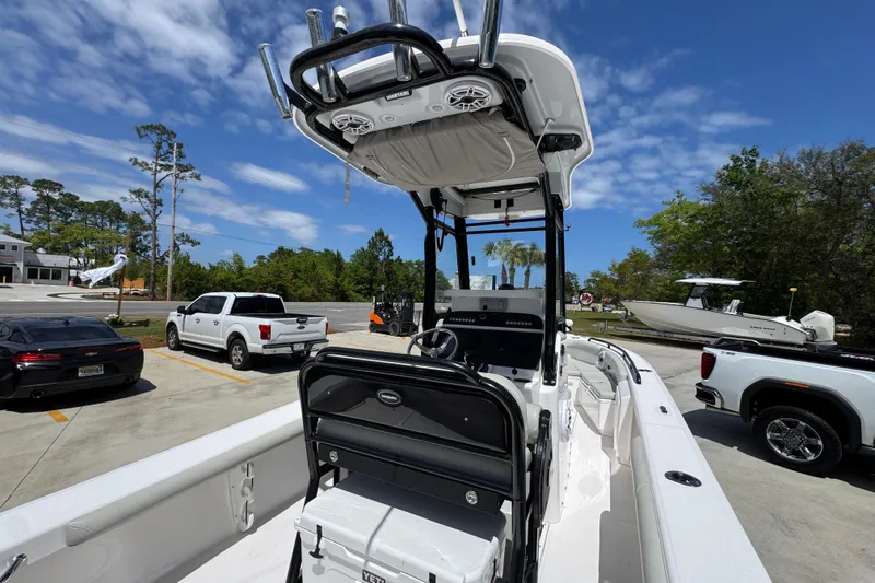 Slide: The Image of 2022 Everglades 243 Center Console boat in parking lot, surrounded by vehicles and trees. - 35