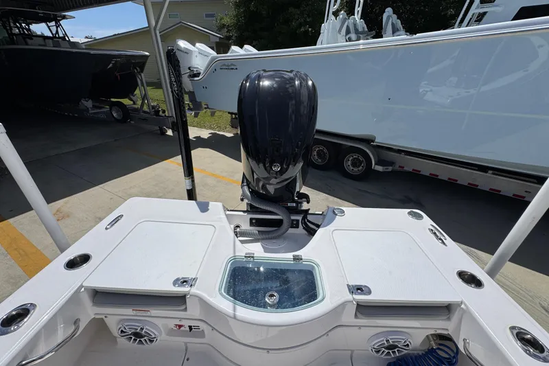 Slide: The Image of 2022 Everglades 243 Center Console boat with powerful outboard motor in a marina setting. - 37