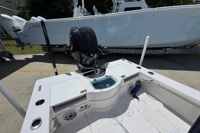 Slide: The Image of 2022 Everglades 243 Center Console boat with outboard motor, docked on concrete. - 38