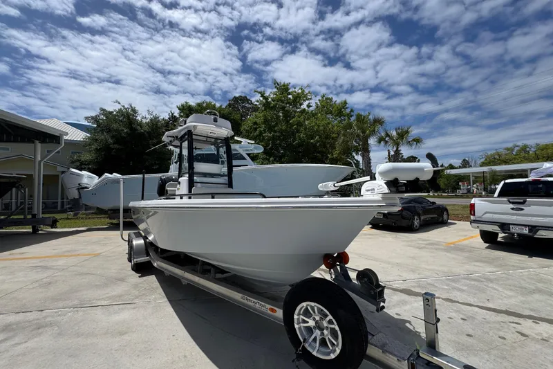 Slide: The Image of 2022 Everglades 243 Center Console boat on trailer under a partly cloudy sky. - 6