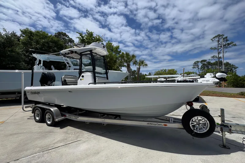 Slide: The Image of 2022 Everglades 243 Center Console boat on trailer under a partly cloudy sky. - 7