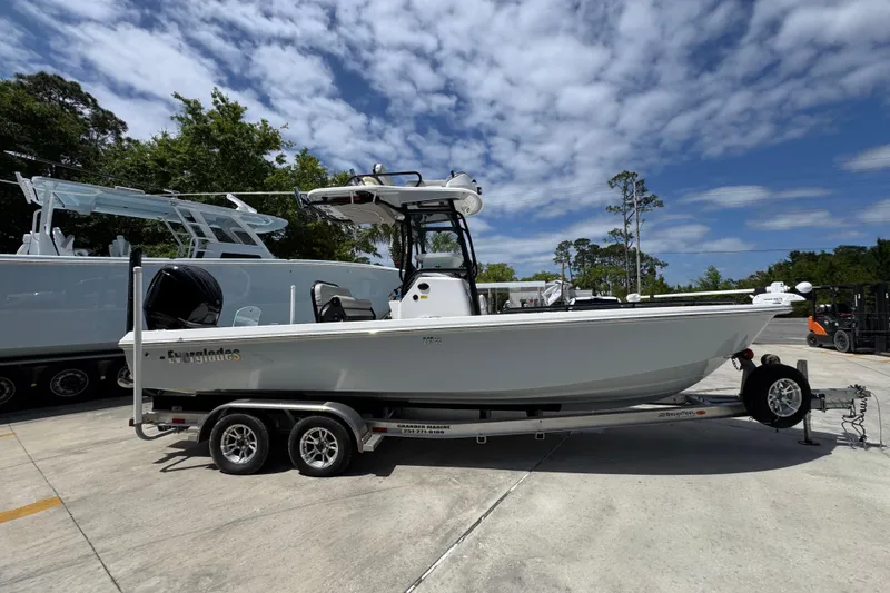 Slide: The Image of 2022 Everglades 243 Center Console boat on trailer under blue sky. - 8