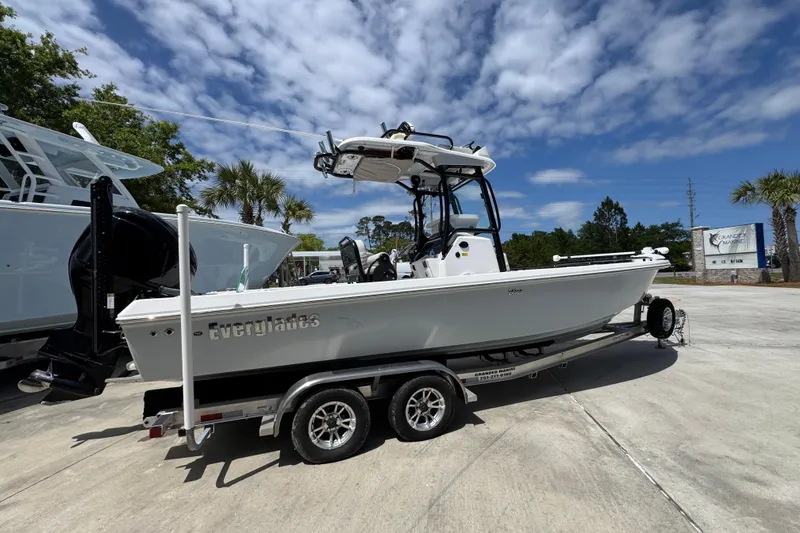 Slide: The Image of 2022 Everglades 243 Center Console boat on trailer under blue sky. - 9