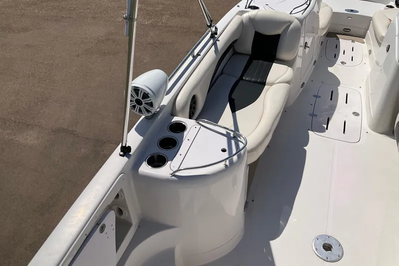 Slide: The Image of 2011 Tahoe 225 boat interior with white seating and cup holders. - 10