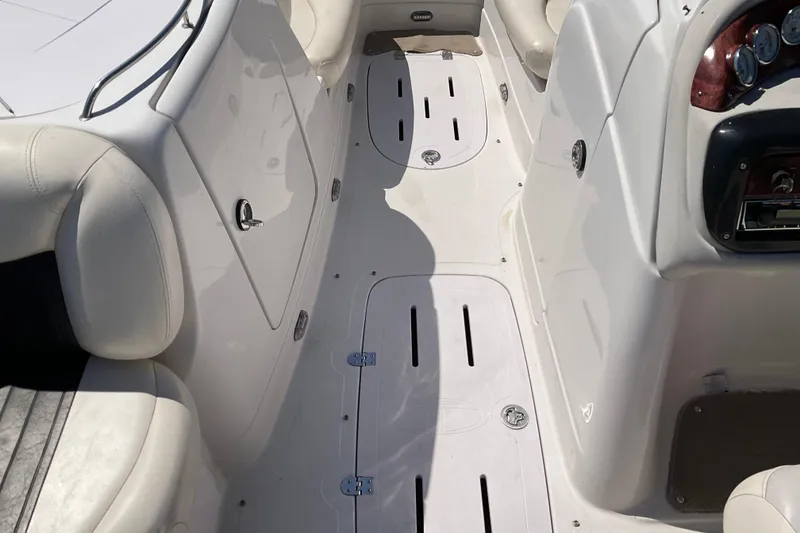 Slide: The Image of Interior view of a 2011 Tahoe 225 boat, featuring white seating and sleek dashboard. - 13