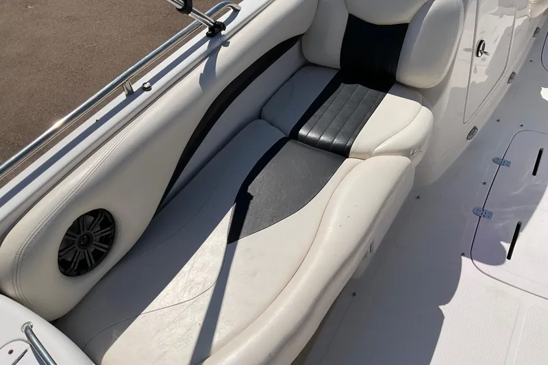 Slide: The Image of Interior seating of a 2011 Tahoe 225 boat with white and black upholstery. - 14