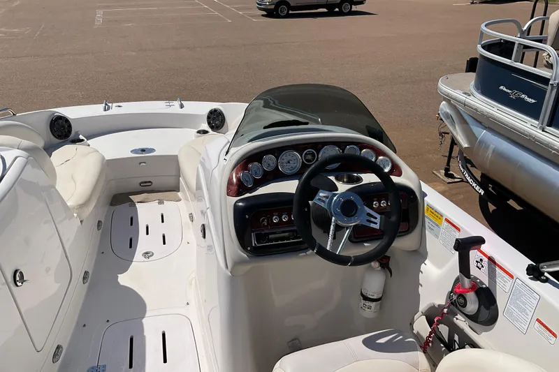 Slide: The Image of Interior view of a 2011 Tahoe 225 boat dashboard and seating area. - 15
