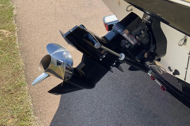 Slide: The Image of 2011 Tahoe 225 boat with a shiny MerCruiser propeller on a paved surface. - 17