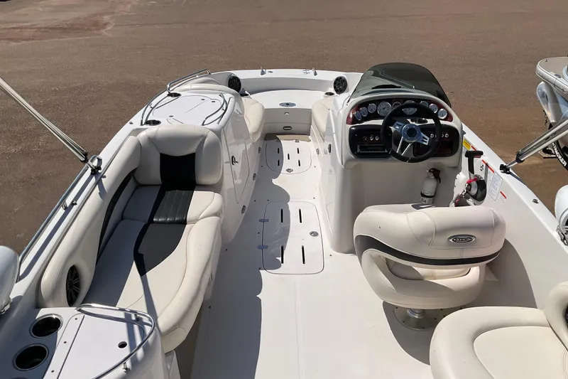 Slide: The Image of 2011 Tahoe 225 boat interior with white seating and modern dashboard controls. - 4