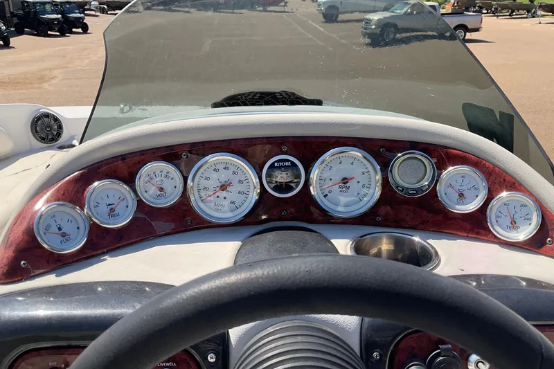 Slide: The Image of Dashboard of a 2011 Tahoe 225 boat with various gauges and controls. - 6