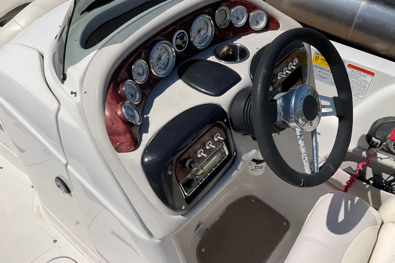 Slide: The Image of Dashboard of a 2011 Tahoe 225 boat with gauges and steering wheel. - 7