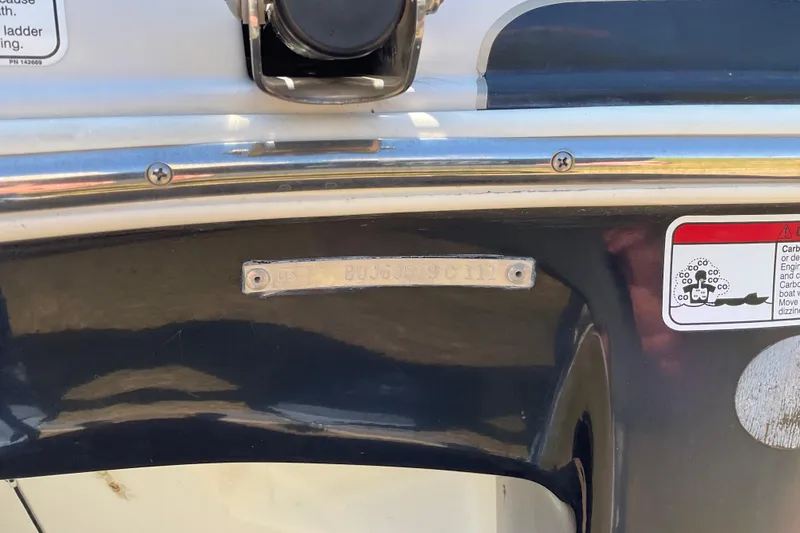 Slide: The Image of 2011 Tahoe 225 boat stern with identification plate and safety warning label. - 9