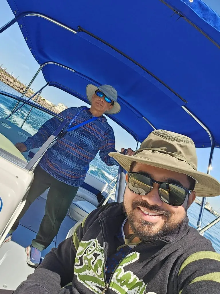 Slide: The Image of Two men on a 1995 Sea Ray 19 Open Bow boat. - 6