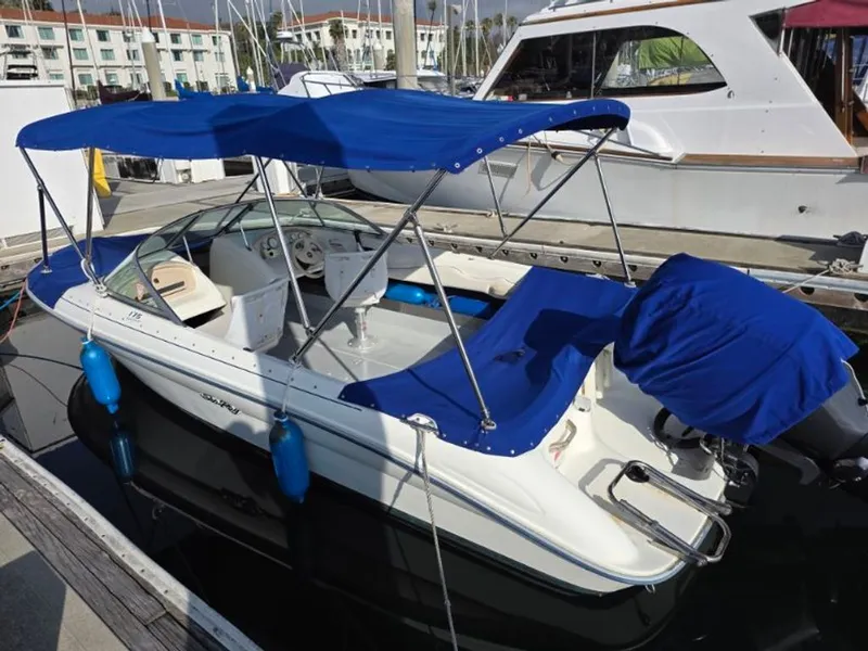 Slide: The Image of 1995 Sea Ray 19 Open Bow boat docked with blue canopy. - 8