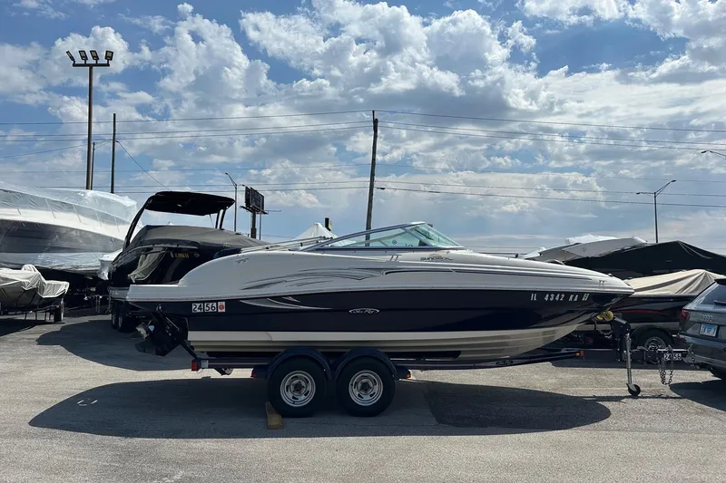 Slide: The Image of 2005 Sea Ray 200 Sundeck boat on trailer under cloudy sky. - 1
