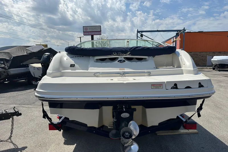 Slide: The Image of 2005 Sea Ray 200 Sundeck boat on trailer, outdoor display under cloudy sky. - 2
