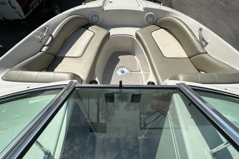 Slide: The Image of 2005 Sea Ray 200 Sundeck interior with cushioned seating and speakers. - 3