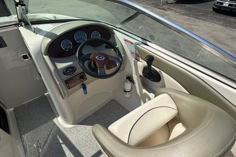 Slide: The Image of 2005 Sea Ray 200 Sundeck boat cockpit with steering wheel and controls. - 6