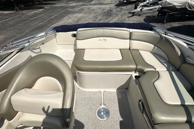 Slide: The Image of 2005 Sea Ray 200 Sundeck interior with beige seating and carpeted floor. - 7