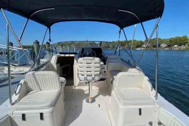 Slide: The Image of 2004 Grady-White Express 265 boat interior with seating and canopy on a sunny day. - 4