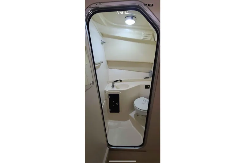 Slide: The Image of Interior view of 2004 Grady-White Express 265 boat bathroom with sink and toilet. - 5
