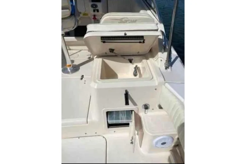 Slide: The Image of 2004 Grady-White Express 265 boat interior with sink and storage compartments. - 6