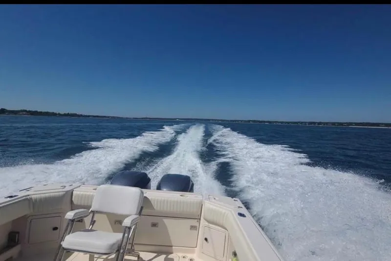 Slide: The Image of 2004 Grady-White Express 265 boat cruising on open water, leaving a wake behind. - 7