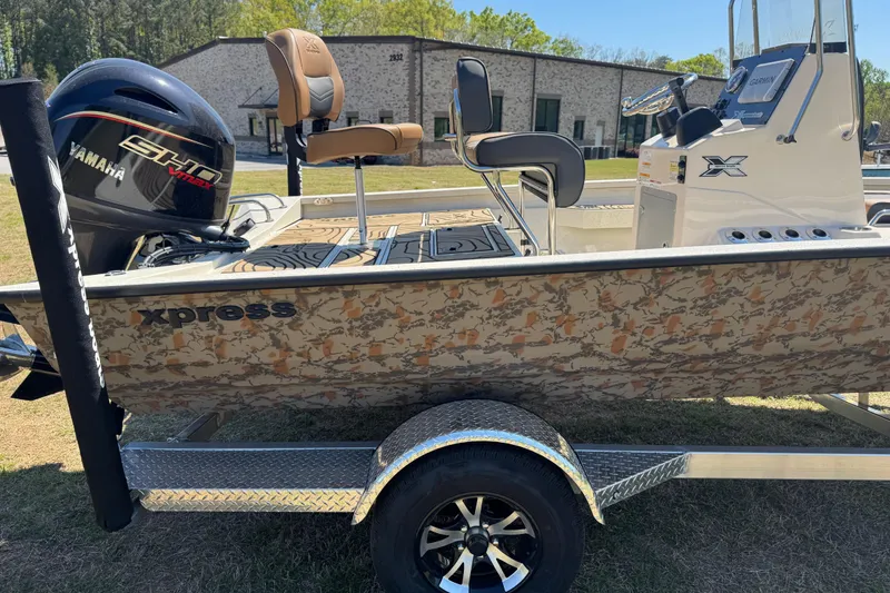 Slide: The Image of 2026 Xpress H20B Bay boat with Yamaha engine on trailer, camo design. - 11