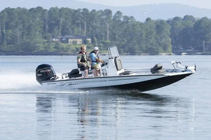 Slide: The Image of Manufacturer Provided Image: 2026 Xpress H20B Bay boat cruising on a lake with two passengers. - 15