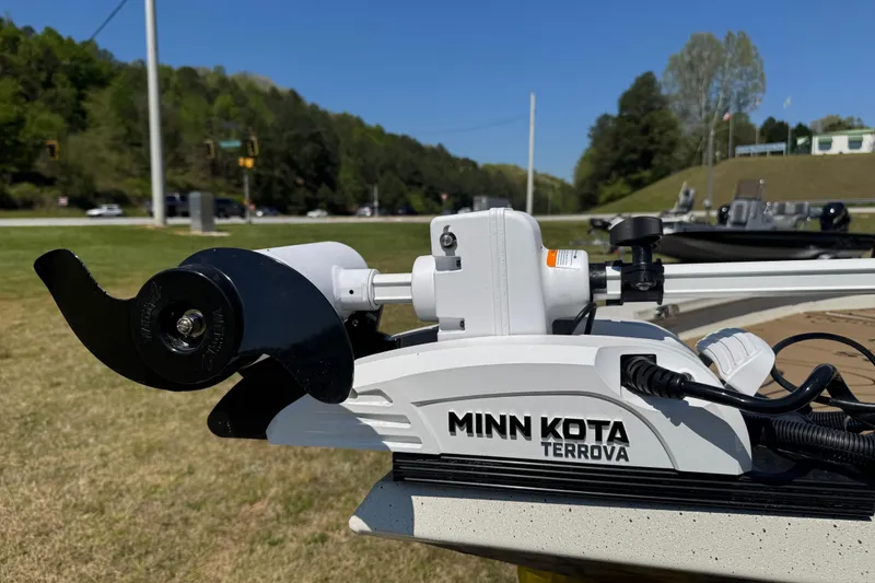 Slide: The Image of Minn Kota Terrova motor on 2026 Xpress H20B Bay boat, grassy area background. - 2