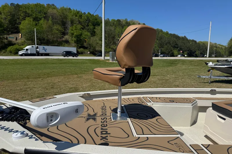 Slide: The Image of 2026 Xpress H20B Bay boat with tan seating and Minn Kota trolling motor. - 4