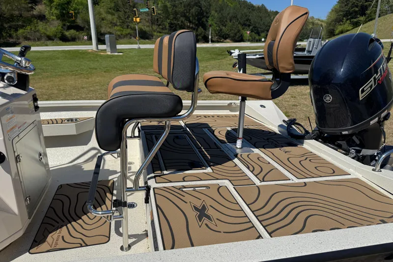 Slide: The Image of 2026 Xpress H20B Bay boat interior with stylish seating and Yamaha outboard motor. - 7