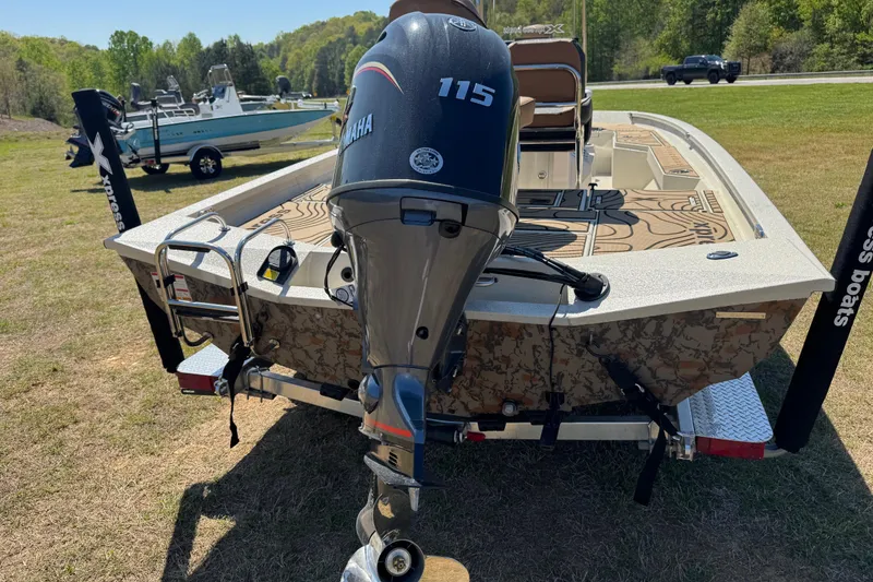 Slide: The Image of 2026 Xpress H20B Bay boat with Yamaha 115 engine on grassy area. - 9