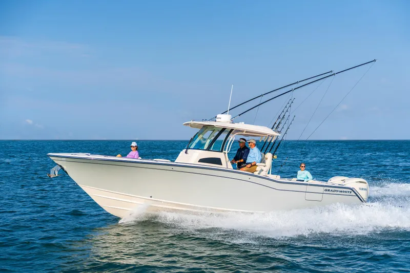 The Image of 2026 Grady-White Canyon 326 boat cruising on open water with passengers. - 0