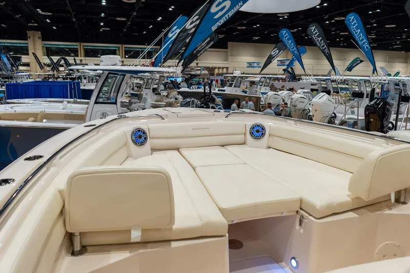 Slide: The Image of 2026 Grady-White Canyon 326 boat interior at a boat show, showcasing luxurious seating. - 19