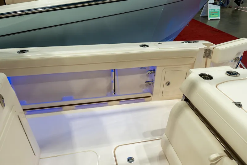 Slide: The Image of 2026 Grady-White Canyon 326 boat interior with storage compartments and seating. - 27