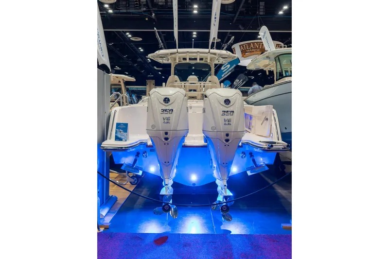 Slide: The Image of 2026 Grady-White Canyon 326 boat with dual 350 V8 engines, showcased under blue lighting. - 3
