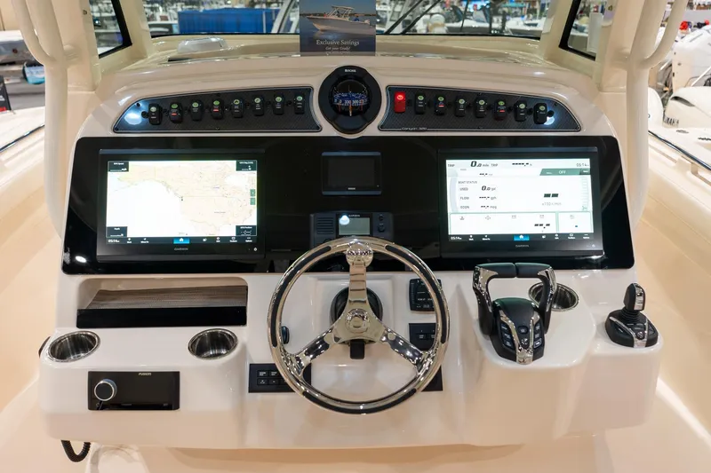 Slide: The Image of Helm of 2026 Grady-White Canyon 326 boat with advanced navigation displays and controls. - 5