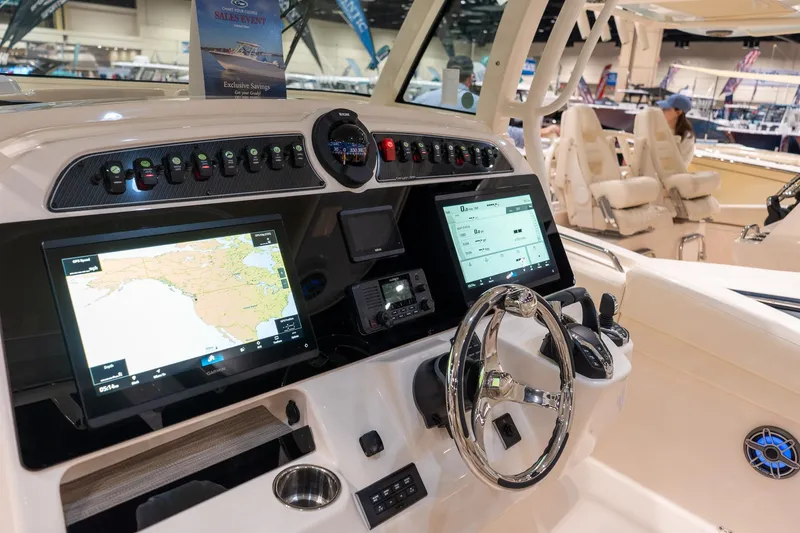 Slide: The Image of 2026 Grady-White Canyon 326 boat dashboard with advanced navigation and control systems. - 6